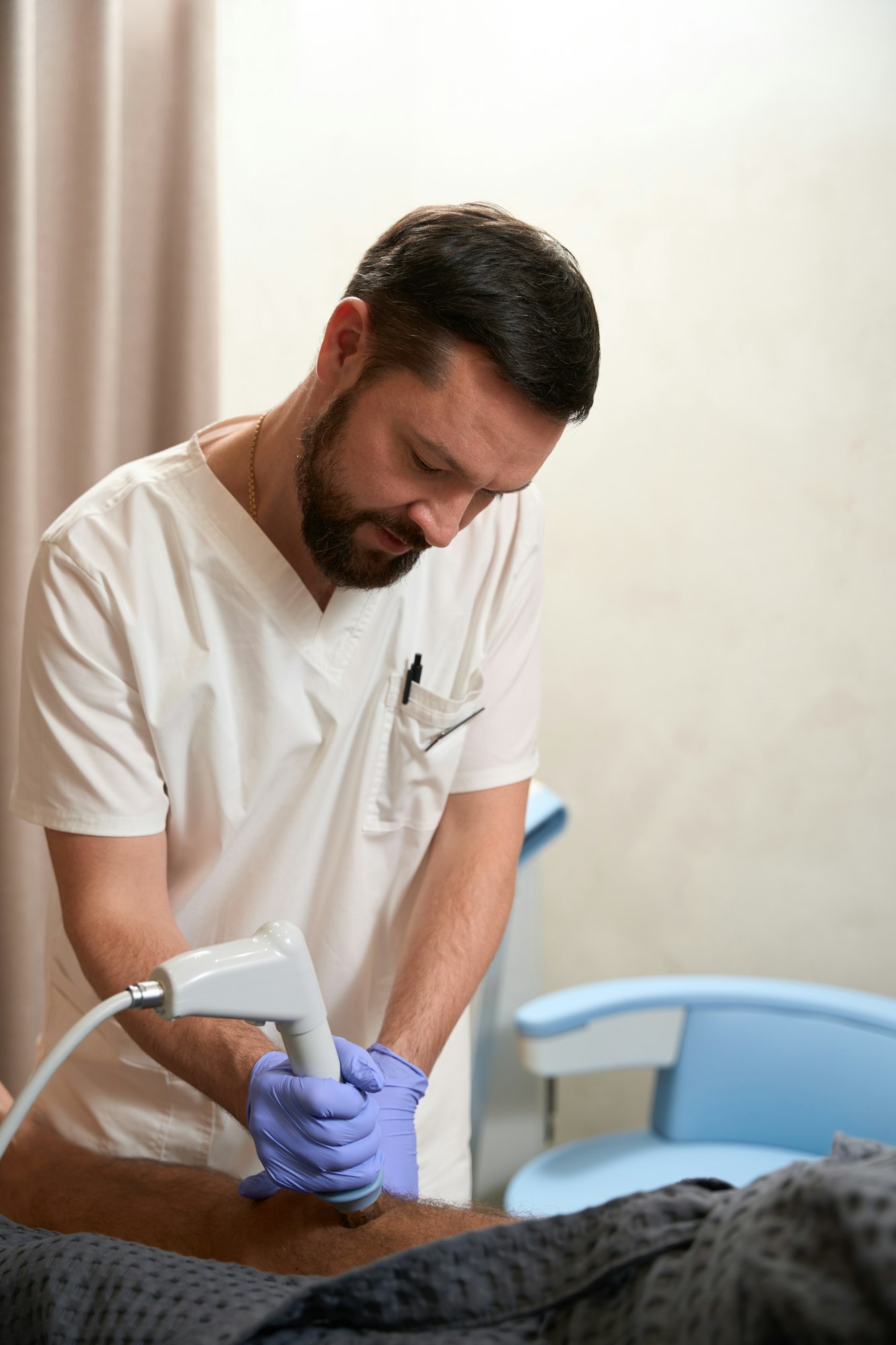 Physiotherapist using progressive radiofrequency treatment on patient at clinic
